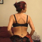 Sexy brunette woman undresses and removes her stockings and lingerie in the bedroom on Adult XXX Video