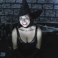 sexy witch in halloween costume with hat gloves corset top smiling in warlock den setting decoration with tara tainton on XXX amateur adult video with free preview