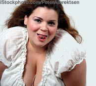 sexy bbw larger curvy woman with large natural breasts in peasant blouse with long brown wavy hair and sticking out her tongue seductively